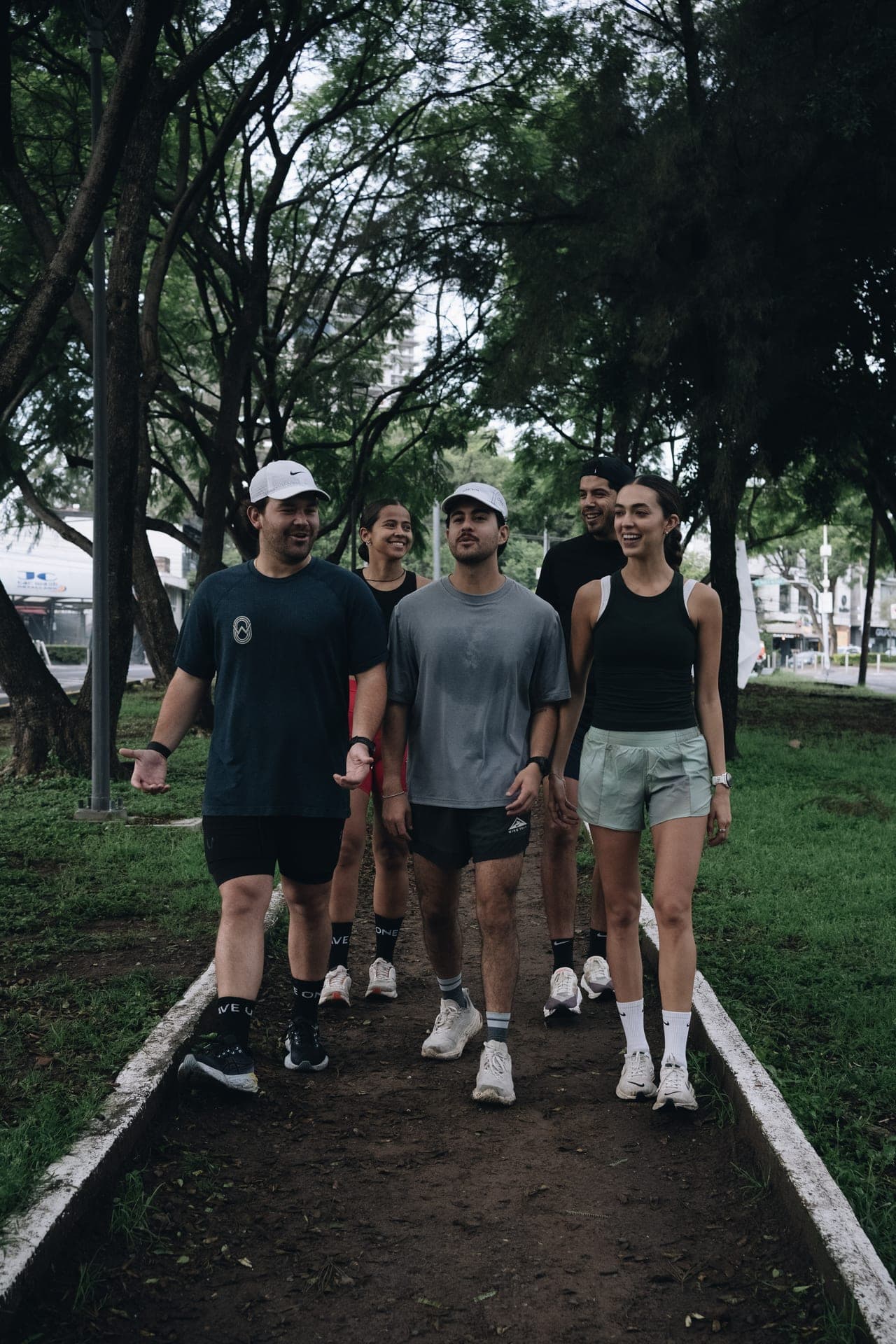 Group portrait of four Wavers smiling on a Berlin path